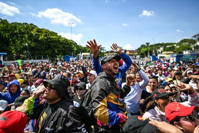 People take part in a demonstration on Youth Day in Caracas on November 13, 2025. (Photo by Juan BARRETO / AFP)