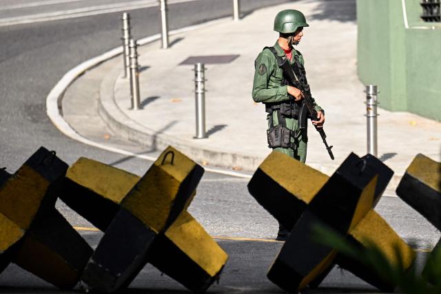 A Venezuelan army soldier guards a street in Caracas on November 13, 2025. (Photo by Juan BARRETO / AFP)