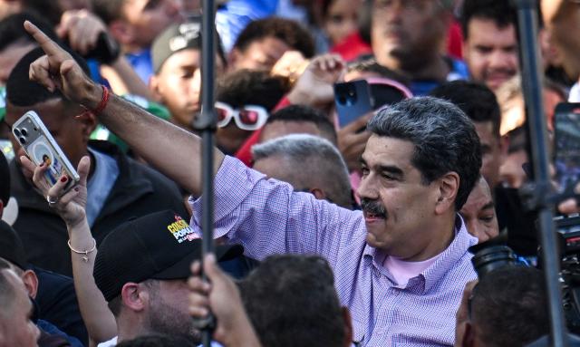 Venezuela's President Nicolas Maduro gestures during a demonstration on Youth Day in Caracas on November 13, 2025. (Photo by Juan BARRETO / AFP)