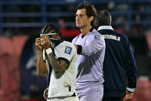 Guatemala's goalkeeper #01 Nicholas Hagen (R) comforts his teammate defender #16 Jose Morales (L) after losing the 2026 FIFA World Cup Concacaf qualifier football match between Guatemala and Panama at the Cementos Progreso stadium in Guatemala City on November 13, 2025. (Photo by Johan ORDÓÑEZ / AFP)