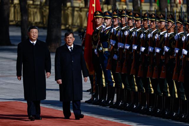 Thailand's King Maha Vajiralongkorn and Chinese President Xi Jinping (L) review an honour guard during a welcoming ceremony at the Great Hall of the People in Beijing on November 14, 2025. (Photo by TINGSHU WANG / POOL / AFP)