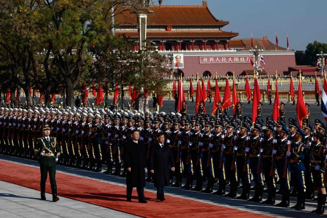 Thailand's King Maha Vajiralongkorn and Chinese President Xi Jinping (L) review an honour guard during a welcoming ceremony at the Great Hall of the People in Beijing on November 14, 2025. (Photo by TINGSHU WANG / POOL / AFP)