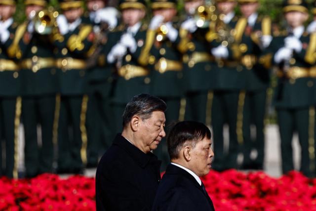 Thailand's King Maha Vajiralongkorn and Chinese President Xi Jinping (L) review an honour guard during a welcoming ceremony at the Great Hall of the People in Beijing on November 14, 2025. (Photo by TINGSHU WANG / POOL / AFP)