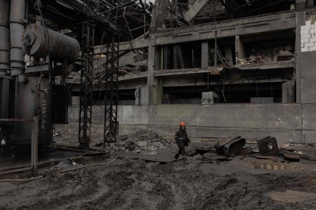 An employee walks at a power plant of Ukrainian energy provider DTEK, which was damaged by constant Russian air attacks, at an undisclosed location on November 13, 2025, amid the Russian invasion of Ukraine. Russia has escalated aerial attacks on Ukrainian energy facilities and rail systems over recent weeks, mirroring similar campaigns launched over the previous three winters that left people without heating in frigid temperatures. (Photo by Roman PILIPEY / AFP)