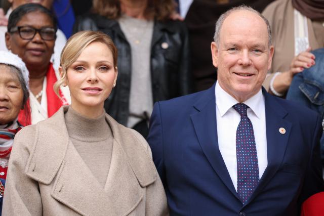Princess Charlene of Monaco (L) and Prince Albert II of Monaco (R) pose with ederly women at the end of a charity event to distribute parcels of Red Cross to elderly people in Monaco on November 14, 2025. (Photo by Valery HACHE / AFP) / NO TABLOIDS WEB & PRINT, NO DAILY MAIL, NO DAILY MAIL GROUP, NO VOICI, NO CLOSER