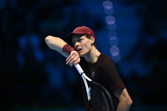 Italy's Jannik Sinner wipes off his face during his match against USA's Ben Shelton at the ATP Finals tennis tournament in Turin on November 14, 2025. (Photo by Marco BERTORELLO / AFP)