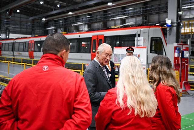 Britain's King Charles III chats with apprentices during a visit to officially open the South Wales Metro Depot in the South Wales town of Taff’s Well on November 14, 2025, as the king marks his 77th birthday. (Photo by Finnbarr Webster / POOL / AFP)