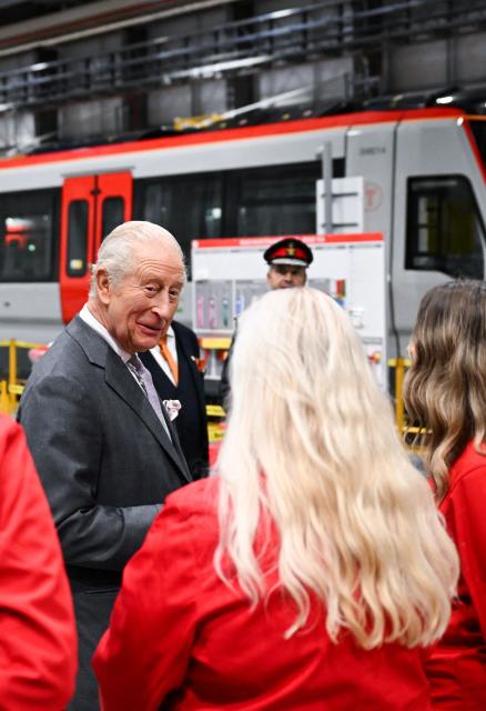 Britain's King Charles III chats with apprentices during a visit to officially open the South Wales Metro Depot in the South Wales town of Taff’s Well on November 14, 2025, as the king marks his 77th birthday. (Photo by Finnbarr Webster / POOL / AFP)