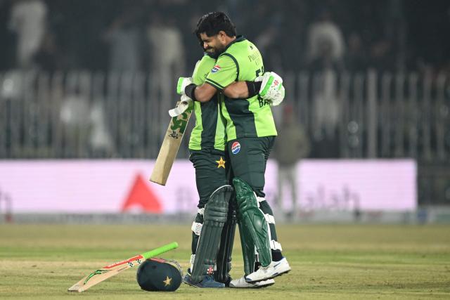 Pakistan's Babar Azam (R) celebrates with Mohammad Rizwan (L) after scoring century (100 runs) and during the second one-day international (ODI) cricket match between Pakistan and Sri Lanka at the Rawalpindi Cricket Stadium in Rawalpindi on November 14, 2025. (Photo by Farooq NAEEM / AFP)