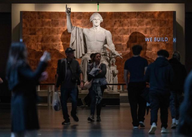 Visitors walk through the American History museum on the first day of the Smithson museum openings after the US Government reopened on the National Mall in Washington, DC on November 14, 2025. After 43 days, the waiting came to an end on November 14, 2025, when President Donald Trump signed a bill funding the government through January -- the result of a deal brokered by Republicans and a handful of moderate Democratic lawmakers. (Photo by ANDREW CABALLERO-REYNOLDS / AFP)