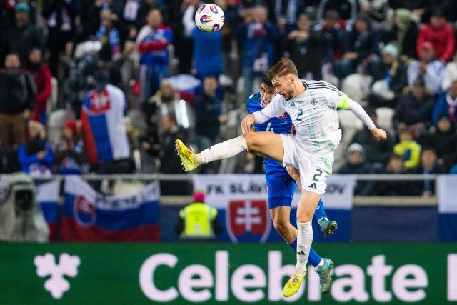 Slovakia's defender #04 Adam Obert and Northern Ireland's defender #02 Conor Bradley (R) vie for the ball during the 1st round - Group A World Cup 2026 European Qualifiers football match between Slovakia and Northern Ireland on November 14, 2025 in Kosice, Slovakia. (Photo by Branislav Racko / AFP)