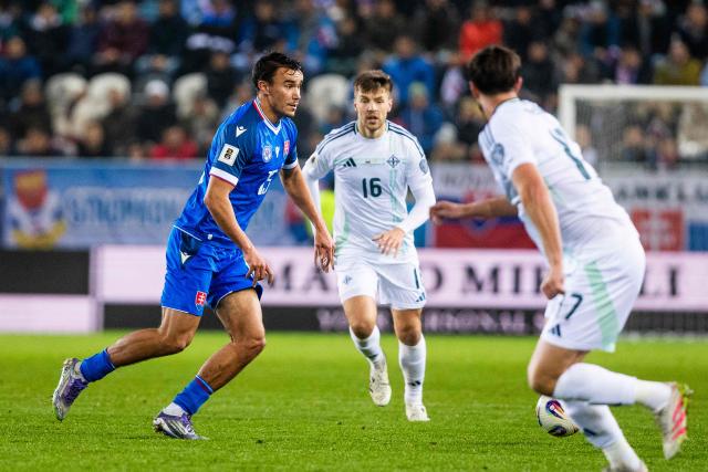 Slovakia's forward #15 David Strelec (L), Northern Ireland's midfielder #16 Bradley Lyons (C) and Northern Ireland's defender #17 Paddy McNair vie for the ball during the 1st round - Group A World Cup 2026 European Qualifiers football match between Slovakia and Northern Ireland on November 14, 2025 in Kosice, Slovakia. (Photo by Branislav Racko / AFP)