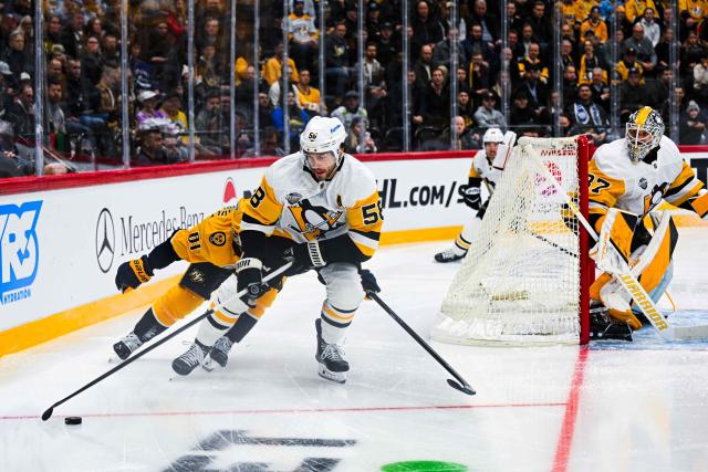 Pittsburgh Penguins' defender #58 Kris Letang (2L) vies for the puck with Nashville Predators' forward #81 Jonathan Marchessault during the NHL Global Series Sweden ice hockey match between Pittsburgh Penguins and Nashville Predators at Avicii Arena in Stockholm, Sweden, on November 14, 2024. (Photo by Jonathan NACKSTRAND / AFP)
