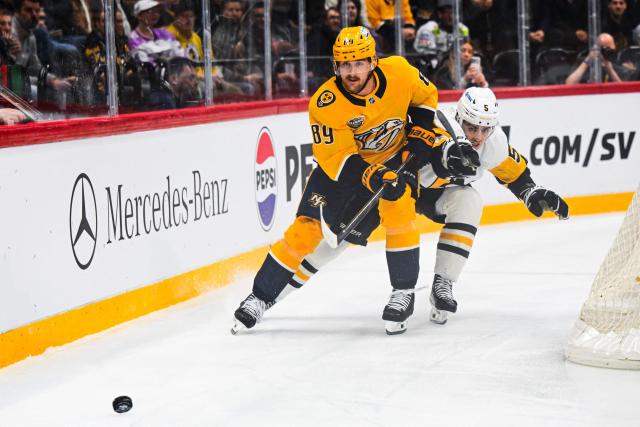 Nashville Predators' forward #89 Ozzy Wiesblatt vies for the puck with Pittsburgh Penguins' defender #05 Ryan Shea during the NHL Global Series Sweden ice hockey match between Pittsburgh Penguins and Nashville Predators at Avicii Arena in Stockholm, Sweden, on November 14, 2024. (Photo by Jonathan NACKSTRAND / AFP)