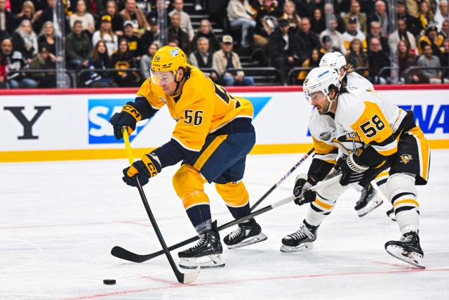 Nashville Predators' #56 forward Erik Haula vies for the puck with Pittsburgh Penguins' defender #58 Kris Letang during the NHL Global Series Sweden ice hockey match between Pittsburgh Penguins and Nashville Predators at Avicii Arena in Stockholm, Sweden, on November 14, 2024. (Photo by Jonathan NACKSTRAND / AFP)