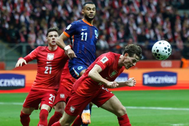 Poland's midfielder #13 Jakub Kaminski (R) heads the ball during the 1st round - day 9 - Group G World Cup 2026 European Qualifiers football match between Poland and the Netherlands on November 14, 2025 in Warsaw, Poland. (Photo by Wojtek RADWANSKI / AFP)