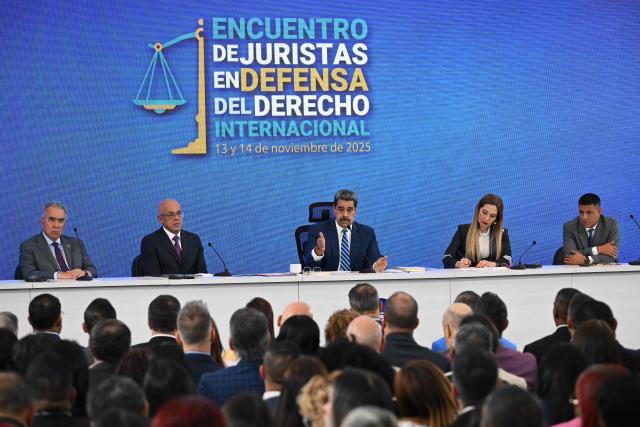 Venezuela's President Nicolas Maduro (C) speaks next to National Assembly President Jorge Rodriguez (2nd L), Supreme Court of Justice President Caryslia Rodriguez (2nd R), Congressman Luis Eduardo Martinez (L) and National Assembly First Vice President Pedro Infante during the Meeting of Jurists in Defense of International Law at the Eurobuilding Hotel in Caracas on November 14, 2025. (Photo by Federico PARRA / AFP)