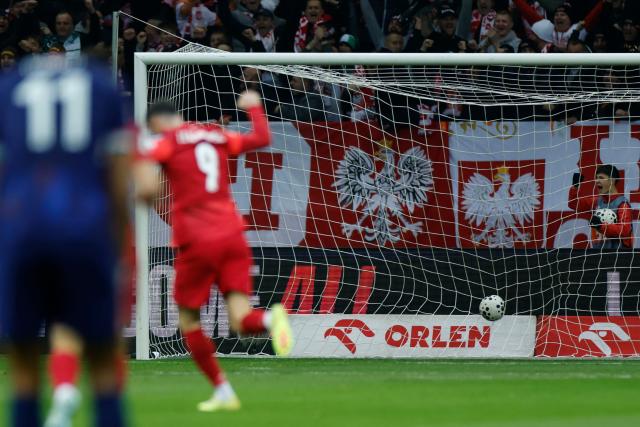 Poland's forward #09 Robert Lewandowski reacts as the ball hits the goal 1-0 by Poland's midfielder #13 Jakub Kaminski (not pictured) during the 1st round - day 9 - Group G World Cup 2026 European Qualifiers football match between Poland and the Netherlands on November 14, 2025 in Warsaw, Poland. (Photo by Wojtek RADWANSKI / AFP)