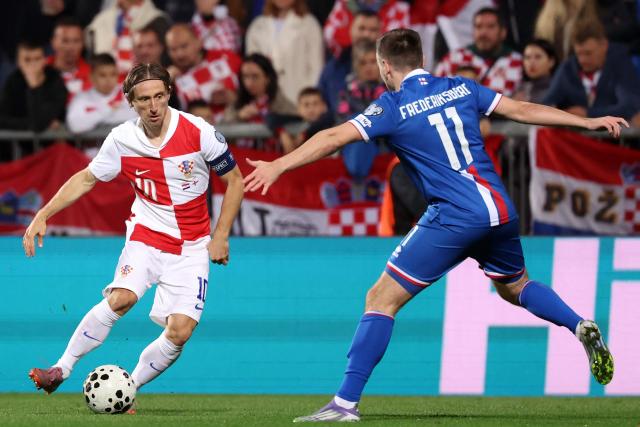 Croatia's midfielder #10 Luka Modric (L) fights for the ball with Faroe's midfielder #11 Arni Frederiksberg during the 2026 World Cup qualifiers Europe zone group L football match between Croatia and Faroe Islands at the Stadion HNK in Rijeka, on November 14, 2025. (Photo by AFP)