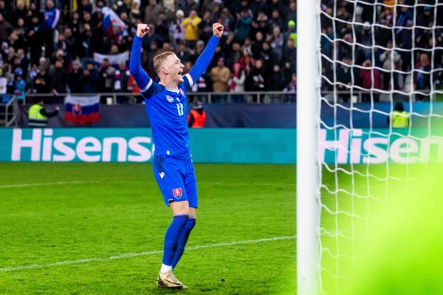 Slovakia's forward #08 Tomas Bobcek celebrates with fans after the World Cup 2026 European Qualifiers football match between Slovakia and Northern Ireland on November 14, 2025 in Kosice, Slovakia. Slovakia won the match 1-0. (Photo by Branislav Racko / AFP)