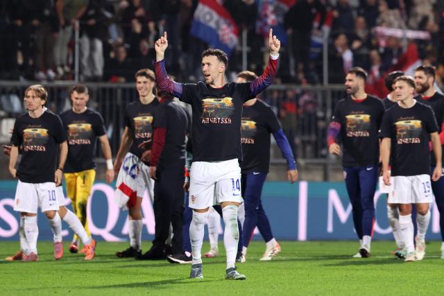 Croatia's forward #14 Ivan Perisic (C) celebrates his team'squalification for the World Cup at the end of the 2026 World Cup qualifiers Europe zone group L football match between Croatia and Faroe Islands at the Stadion HNK in Rijeka, on November 14, 2025. (Photo by AFP)