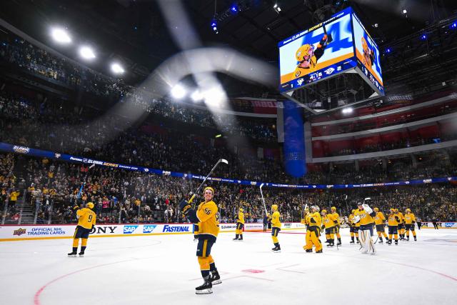 Nashville Predators' players celebrate with supporters after winning the NHL Global Series Ice Hockey match between Pittsburgh Penguins and Nashville Predators in Stockholm on November 14, 2025. Nashville Predators won the match 2-1. (Photo by Jonathan NACKSTRAND / AFP)