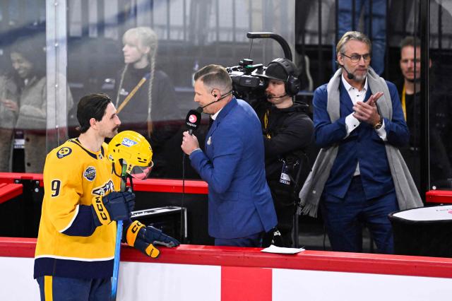 Nashville Predators' Filip Forsberg (L) is interviewed by tv host Niklas Jihde (C) next to former NHL player Peter Forsberg after the NHL Global Series Sweden ice hockey match between Pittsburgh Penguins and Nashville Predators at Avicii Arena in Stockholm, Sweden, on November 14, 2025.  (Photo by Henrik MONTGOMERY / TT NEWS AGENCY / AFP) / Sweden OUT