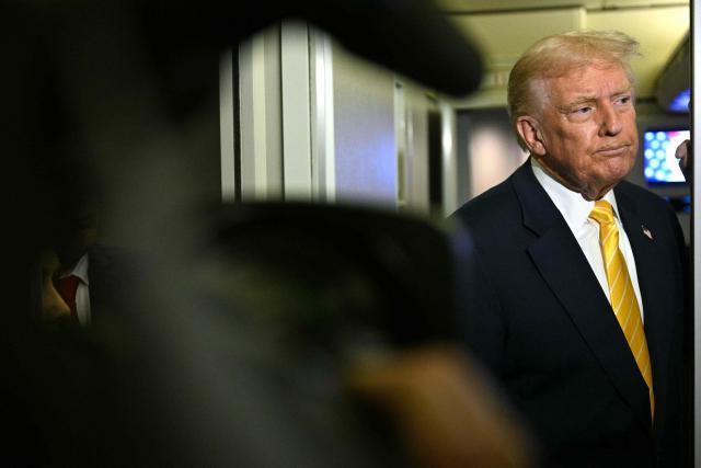 US President Donald Trump speaks to reporters aboard Air Force One en route to Palm Beach, Florida, on November 14, 2025. Trump is headed to his Mar-a-Lago, Florida, residence where he will spend the weekend. (Photo by Jim WATSON / AFP)