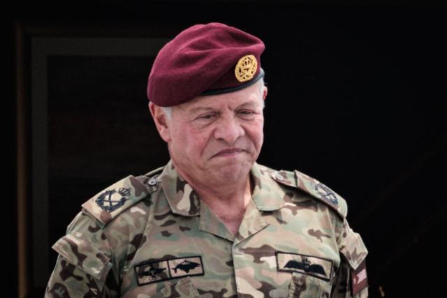 Jordan's King Abdullah II stands in front of the aircraft door before departure at Halim Perdanakusuma Air Force Base in Jakarta on November 15, 2025. (Photo by YASUYOSHI CHIBA / AFP)