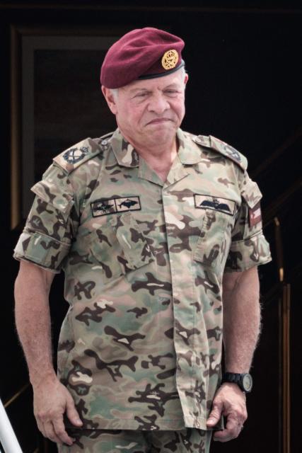 Jordan's King Abdullah II stands in front of the aircraft door before departure at Halim Perdanakusuma Air Force Base in Jakarta on November 15, 2025. (Photo by YASUYOSHI CHIBA / AFP)
