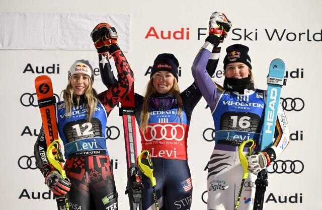 Winner USA's Mikaela Shiffrin (C), second placed Albania's Lara Colturi (L) and third placed Germany's Emma Aicher (R) celebrate on the podium after the second run of the women's slalom event of the FIS Alpine Skiing World Cup at the Levi Ski Centre in Kittila, on November 15, 2025. (Photo by Roni Rekomaa / Lehtikuva / AFP) / Finland OUT