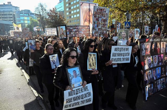 Relatives of the victims of a deadly nightclub fire on March 16, 2025 hold photographs of the deceased as they march to demand justice in Skopje on November 15, 2025. On March 16, a fire at a hip-hop concert in the eastern town of Kocani triggered a stampede in the overcrowded club, leaving 63 dead and injuring nearly 200 -- most aged between 16 and 26. (Photo by Robert ATANASOVSKI / AFP)