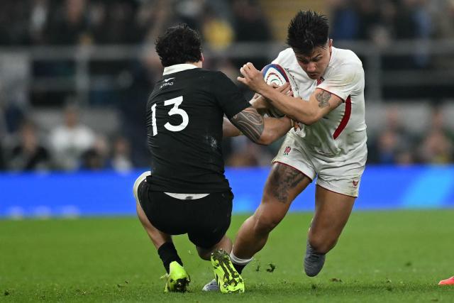 England's Marcus Smith (R) is tackled by New Zealand's centre Billy Proctor (L) during the Autumn Nations Series international rugby union match between England and New Zealand at Allianz Stadium, Twickenham, in south-west London, on November 15, 2025. (Photo by JUSTIN TALLIS / AFP)