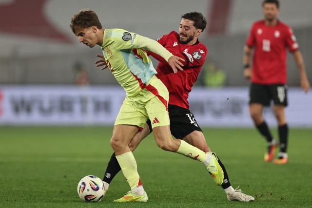 Spain's midfielder #15 Pablo Barrios and Georgia's midfielder #17 Otar Kiteishvili vie for the ball during the FIFA World Cup 2026 European qualification football match between Georgia and Spain at the Boris Paichadze National Stadium in Tbilisi on November 15, 2025. (Photo by Giorgi ARJEVANIDZE / AFP)