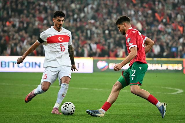 Turkey's defender #15 Samet Akaydin fights for the ball with Bulgaria's defender #02 Hristiyan Petrov during the FIFA World Cup 2026 European qualification football match between Turkey and Bulgaria at the Timsah Arena stadium, in Bursa, on November 15, 2025. (Photo by OZAN KOSE / AFP)