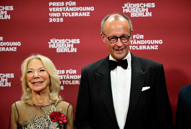 German Chancellor Friedrich Merz (R) and Amy Gutmann, former US Ambassador to Germany and Daniel Zajfman poses as they arrive for the awarding of the "the Prize for Understanding and Tolerance" by the Jewish Museum Berlin (JMB) in Berlin on November 15, 2025. This year, the prize goes to Amy Gutmann, former US Ambassador to Germany, Christopher H. Browne, Professor at the University of Pennsylvania and Daniel Zajfman, former President of the Weizmann Institute of Science and Chairman of the Academic Advisory Board of the Israel Science Foundation. (Photo by Tobias SCHWARZ / AFP)