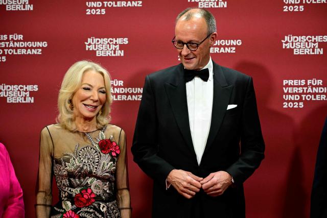 German Chancellor Friedrich Merz (R) and Amy Gutmann, former US Ambassador to Germany and Daniel Zajfman poses as they arrive for the awarding of the "the Prize for Understanding and Tolerance" by the Jewish Museum Berlin (JMB) in Berlin on November 15, 2025. This year, the prize goes to Amy Gutmann, former US Ambassador to Germany, Christopher H. Browne, Professor at the University of Pennsylvania and Daniel Zajfman, former President of the Weizmann Institute of Science and Chairman of the Academic Advisory Board of the Israel Science Foundation. (Photo by Tobias SCHWARZ / AFP)