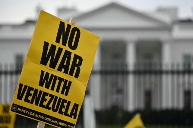 People take part in a "Peace with Venezuela" protest against the US military deployment in Latin America in front of the White House in Washington, DC, on November 15, 2025. (Photo by Drew ANGERER / AFP)