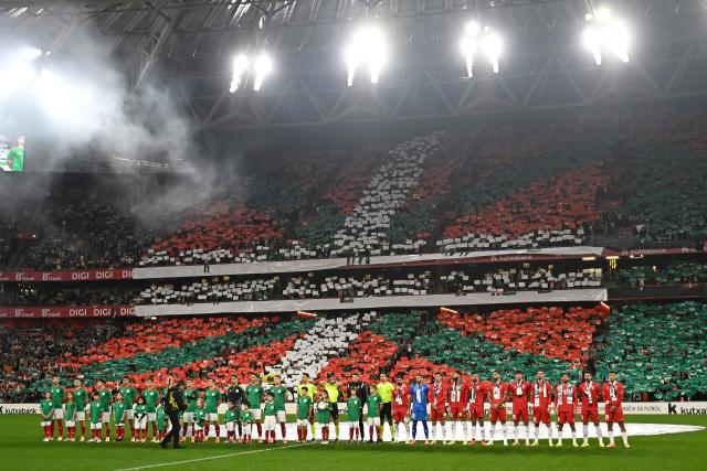 Both teams' players line up on the pitch to listen to their national anthems before the friendly football match between Basque Country and Palestine at San Mames Stadium in Bilbao on November 15, 2025. (Photo by ANDER GILLENEA / AFP)