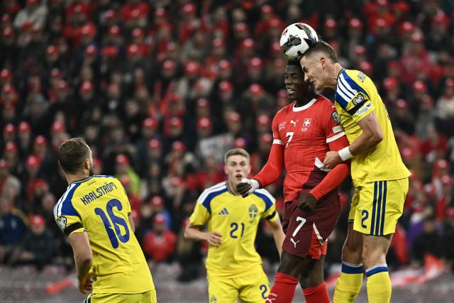 Switzerland's forward #07 Breel Embolo and Sweden's defender #02 Gustaf Lagerbielke jump to head the ball during the FIFA World Cup 2026 Group B European qualification football match between Switzerland and Sweden at the Geneva stadium, in Geneva, on November 15, 2025. (Photo by Fabrice COFFRINI / AFP)
