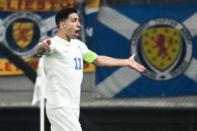 Greece's midfielder #11 Tasos Bakasetas celebrates after scoring his team's first goal during the FIFA World Cup 2026 Group C European qualification football match between Greece and Scotland at the Karaiskakis Stadium in Piraeus, on November 15, 2025. (Photo by Angelos TZORTZINIS / AFP)
