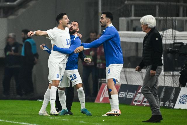Greece's midfielder #11 Tasos Bakasetas (L) celebrates with teammates after scoring Greece's first goal during the FIFA World Cup 2026 Group C European qualification football match between Greece and Scotland at the Karaiskakis Stadium in Piraeus, on November 15, 2025. (Photo by Angelos TZORTZINIS / AFP)