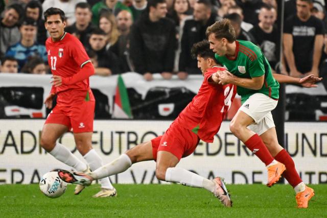 Palestine's midfielder # Ahmad Al-Qaq (C) fights for the ball with Basque Country's forward #24 Borja Sainz (R) during the friendly football match between Basque Country and Palestine at San Mames Stadium in Bilbao on November 15, 2025. (Photo by ANDER GILLENEA / AFP)