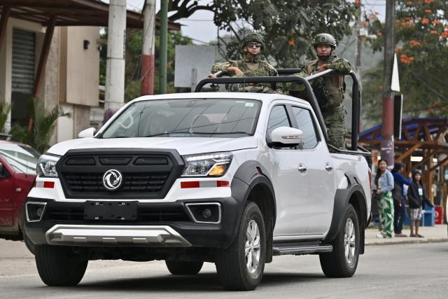 Armed Forces personnel patrol on the eve of the constitutional reform referendum in Olon on November 15, 2025. Ecuadorans will vote Sunday on whether to allow the return of foreign military bases and the drafting of a new constitution that could give the country's Trump-friendly president more power. (Photo by MARCOS PIN / AFP)