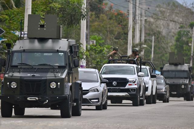 Armed Forces personnel patrol on the eve of the constitutional reform referendum in Olon on November 15, 2025. Ecuadorans will vote Sunday on whether to allow the return of foreign military bases and the drafting of a new constitution that could give the country's Trump-friendly president more power. (Photo by MARCOS PIN / AFP)