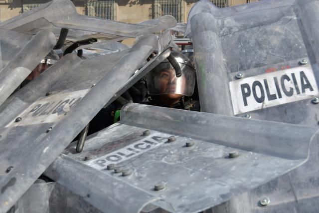 Mexican riot police covered by shields during a protest against the government of Mexican President Claudia Sheinbaum at Zocalo Square in Mexico City on November 15, 2025. (Photo by Rebeca Herrera / AFP)