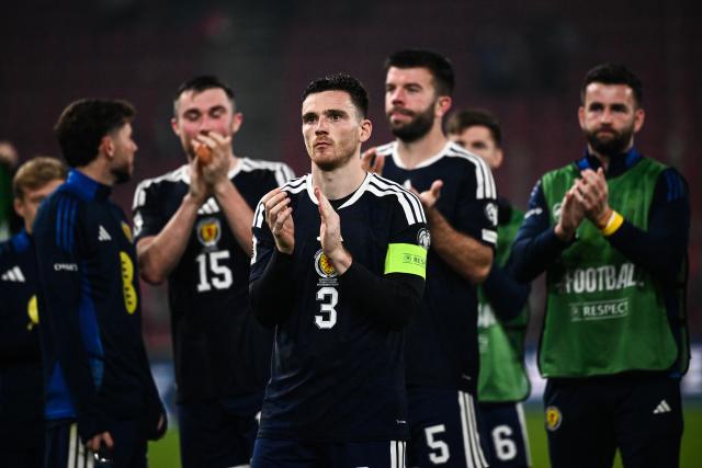 Scotland's defender and captain #03 Andrew Robertson (C) leads his teammates as they acknowledge the fans at the end of the FIFA World Cup 2026 Group C European qualification football match between Greece and Scotland at the Karaiskakis Stadium in Piraeus, on November 15, 2025. (Photo by Angelos TZORTZINIS / AFP)