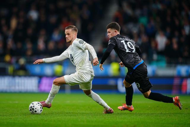 Slovenia's midfielder #19 Tomi Horvat (L) and Kosovo's defender #19 Dion Gallapeni (R) fight for the ball during the FIFA World Cup 2026 Group B European qualification football match between Slovenia and Kosovo at the Stozice Stadium in Ljubljana, on November 15, 2025. (Photo by Jure Makovec / AFP)