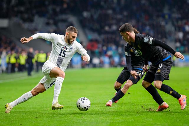 Slovenia's forward #15 Danijel Sturm (L) runs with the ball towards Kosovo's forward #09 Albion Rrahmani (R) during the FIFA World Cup 2026 Group B European qualification football match between Slovenia and Kosovo at the Stozice Stadium in Ljubljana, on November 15, 2025. (Photo by Jure Makovec / AFP)