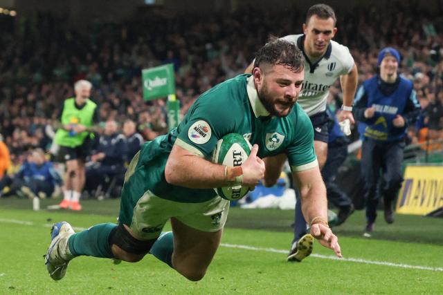 Ireland's centre Robbie Henshaw dives over the line to score their final try during the Autumn Nations Series international rugby union match between Ireland and Australia at the Aviva Stadium in Dublin, on November 15, 2025. (Photo by Paul Faith / AFP)